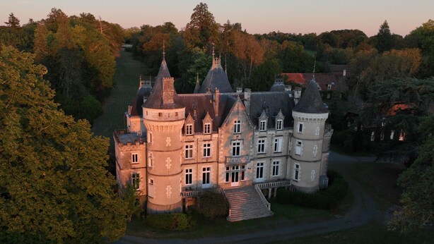 A large, historic castle with multiple towers and a well-maintained garden. - Chateau de la Rose (Cluis)