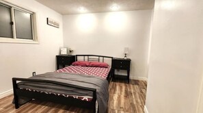 Cozy retreat with a single bed, bedside tables, and lamps.