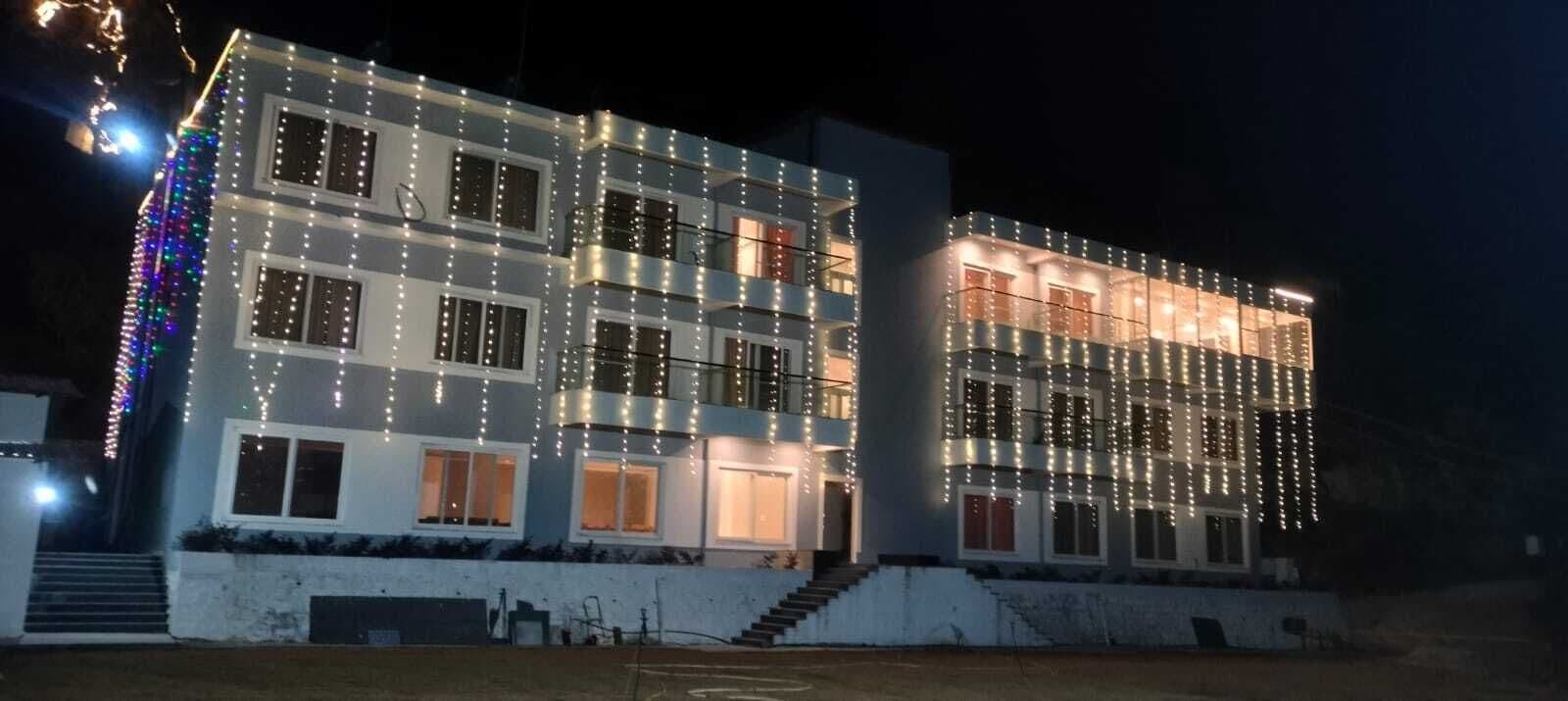 A multi-story building with balconies, windows, and a staircase.