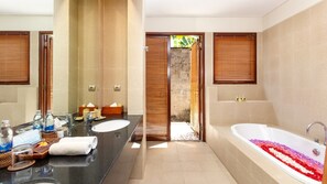 A modern bathroom with a large sink, a bathtub with rose petals, and wooden shutters on the windows. - Airy 7BR Villa With Amazing Hot Tub & Pool, Bali Villa 2234 (Sukawati)