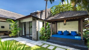 A modern house with a covered outdoor seating area, a stone pathway, and lush greenery. - Rent a Luxury Villa in Bali Close to the Beach, Bali Villa 2016 (Seminyak)