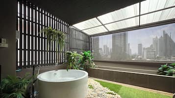 Executive Suite with Outdoor Cave Jetted Hot Tub | Bathroom | Shower, hair dryer, towels, soap
