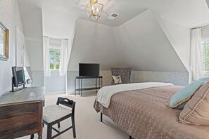 A bedroom with a bed, a desk, a chair, a television, and a window. - Beautiful Villa Leocadia+ Private Pool + Sleeps 8! (Kansas City)