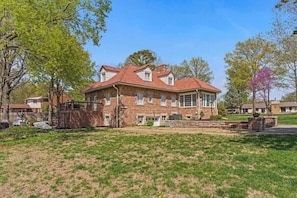 A large brick house with a red-tiled roof, multiple windows, and a well-maintained lawn. - Beautiful Villa Leocadia+ Private Pool + Sleeps 8! (Kansas City)