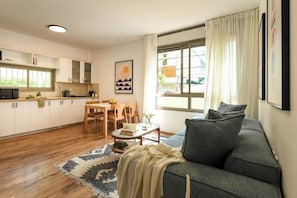 A modern living space with a kitchen, dining area, and seating area.