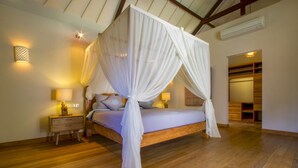 A four-poster canopy bed with a wooden frame, bedside lamps, and a nightstand. - Fantastic 3BR Villa W/ Pool & Garden, Bali Villa 2228 (Ungasan)