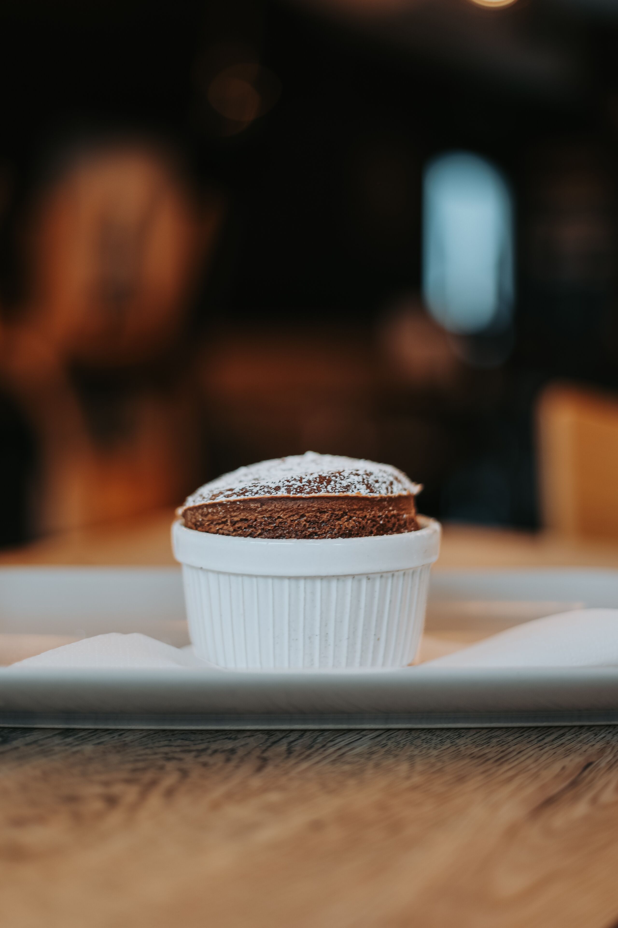 A dessert in a white cup on a white plate.
