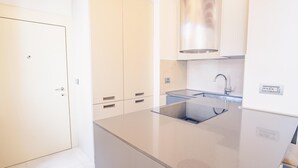 A modern kitchen with a stainless steel sink, a built-in oven, and a white cabinet. - San Giovanni in Valle - Italian Homing (Verona)