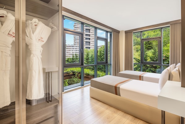 Deluxe Apartment, 3 Bedrooms, Balcony | Minibar, desk, laptop workspace, blackout drapes