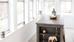 A modern interior with a dark wooden table, shelves, and large windows. - Superior Guest Room w Hot Tub w Outdoor view (New Hope)