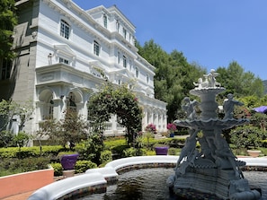 A classical building with a fountain in the foreground. - olliere castle (Puli)