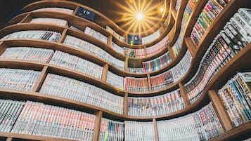 A spiral library with bookshelves arranged in a circular pattern, each shelf labeled with a number.