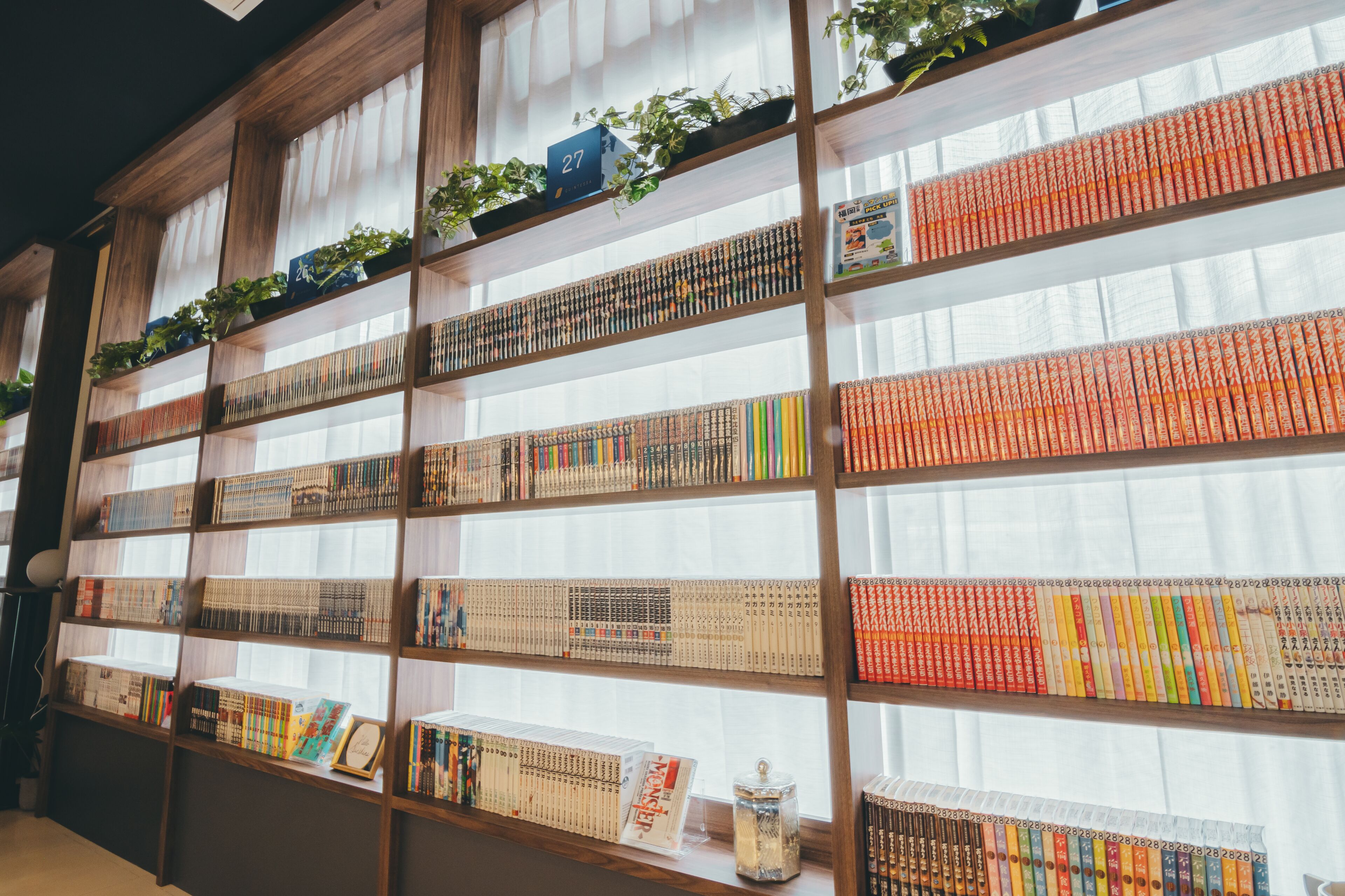 A bookshelf with various books and decorative items.
