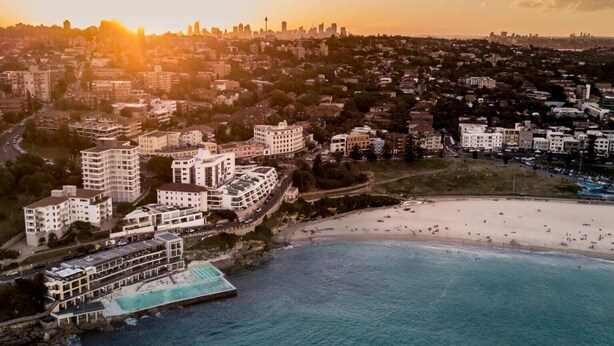 An aerial view of a coastal city with a beach, buildings, and a marina. - Quaint 1BD on the Doorstep of Manly Beach (Manly)