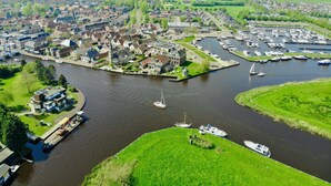 A riverside town with a marina, historic buildings, and a church. - Harboursuite 2 incl. motorboot by Interhome (Woudsend)