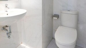 A modern bathroom with a white sink, mirror, toilet, and towel rack. - Collection O Bekasi Timur Near Gedung Juang Formerly Regia Tambun (Cikarang)