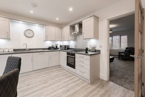 Enjoy cooking in this well-equipped kitchen with oven, ample counter space, and a cozy seating area.
