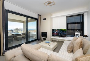 Deluxe Apartment | Living area | 55-inch Smart TV with digital channels, TV, Netflix