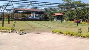 A covered outdoor area with a stage, seating, and a small pavilion. - D Star Entertainment Water ParkAndResort (Chiplun)
