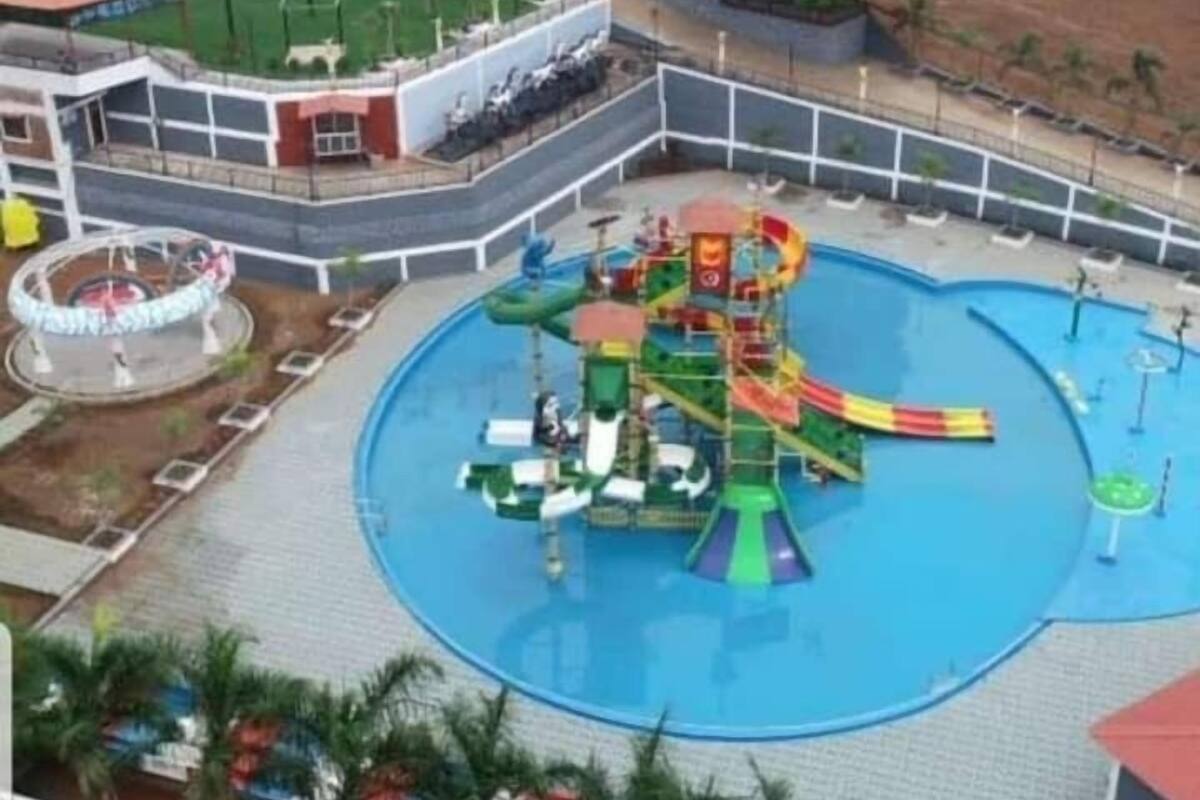 A water park with a large pool, slides, and a play structure.