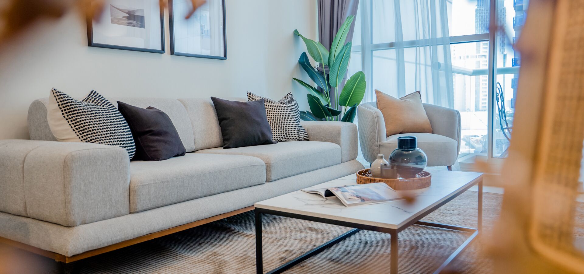 A modern living room with a sofa, a coffee table, and a side table.