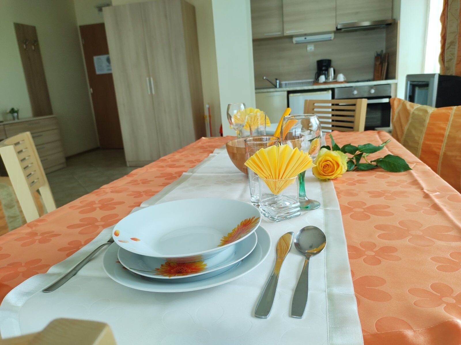 A dining table set with plates, cutlery, and a decorative centerpiece.