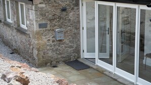 A stone building with a mailbox, a door with glass panels, and a small porch area. - Contemporary Home Nr Kirkby Lonsdale - Spacious Garden (Carnforth)