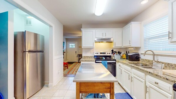 Enjoy cooking in this well-equipped kitchen with a large island and stainless steel appliances.