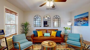 Relax in the living room with a sofa, two armchairs, and a coffee table.