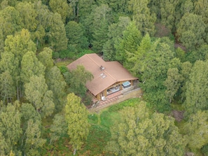 A wooden cabin surrounded by dense forest. - Beaver Creek Lodge -  a lodge that sleeps 8 guests  in 3 bedrooms (Aviemore)