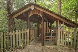 A wooden covered walkway leading to a lodge entrance with a sign reading 'Welcome to Beaver Creek Lodge.' - Beaver Creek Lodge -  a lodge that sleeps 8 guests  in 3 bedrooms (Aviemore)