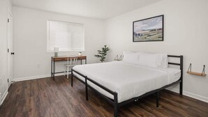 A bedroom with a bed, a desk, and a chair. - Family Friendly Haven I  Renovated & Spacious! (Spokane Valley)