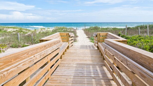 A wooden boardwalk leading to the beach with benches on either side. - Surf N Dolphin, Oceanview House in Emerald Isle, NC! (Emerald Isle)