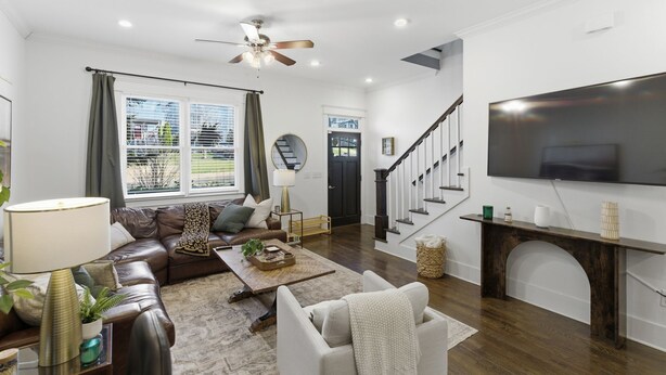 A modern living room with a sofa, coffee table, and TV.