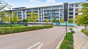 A modern multi-story building with a sign indicating luxury apartments for rent. - Luxury 2 Bed in Sandton Gate (Johannesburg)