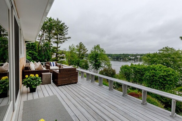 Relax on the deck with a sofa and wicker chair, taking in the views of the surrounding landscape.
