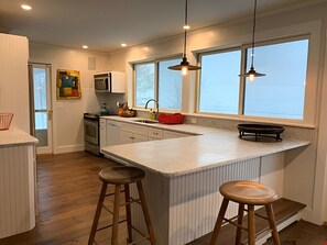Enjoy cooking and dining in this well-equipped kitchen with a large island and ample counter space.