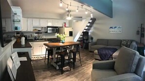 A compact living space with a kitchen, dining area, and seating area. - #166 Condo near large pool & shuttle to Gorge Amp-book separately (Quincy)