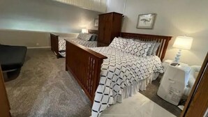 A bedroom with a wooden bed, a nightstand, a desk, and a chair. - #166 Condo near large pool & shuttle to Gorge Amp-book separately (Quincy)