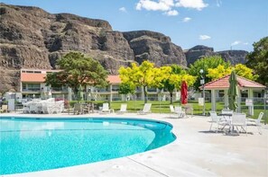 Relax by the pool surrounded by lush greenery and scenic views.