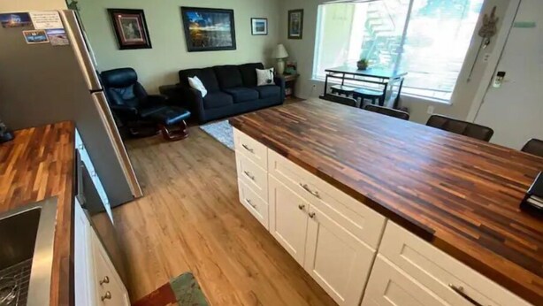 A compact kitchen with a wooden countertop, a dining table, and a sofa in the adjacent living area. - #181 Condo near large pool & shuttle to Gorge Amp-book separately (Quincy)