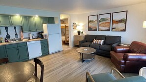 A compact living space with a kitchen, dining area, and seating area.