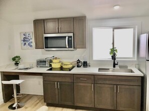 Fridge, microwave, stovetop, coffee/tea maker