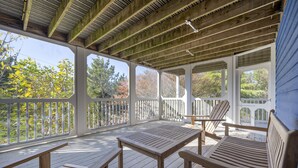 A wooden deck with benches and a table, surrounded by white railings and covered by a wooden roof. - 8 Lighthouse Way - Beautiful home with a private elevator! (Lewes)