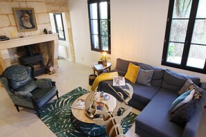 A living room with a fireplace, a sofa, a chair, and a coffee table.