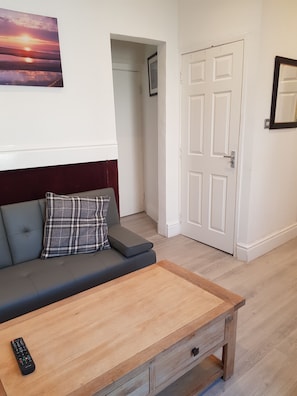 Relax in this stylish living room with a sofa, coffee table, and mirror.