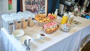 A breakfast buffet with various food items, containers, and a coffee machine. - Lord Kitcheners Guest House (Lowestoft)