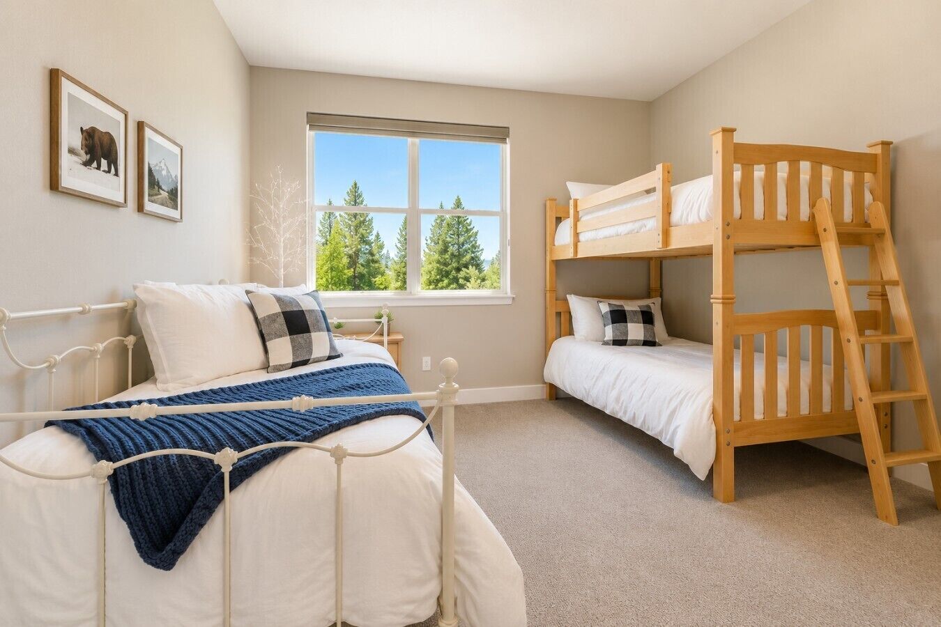 A bedroom with a bunk bed, a single bed, and a window with a view of trees.