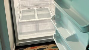 An open refrigerator with multiple shelves and compartments.