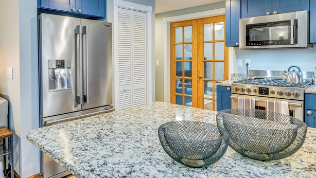 A kitchen with a stainless steel refrigerator, double ovens, a microwave, and a granite countertop. - Saratoga Springs Vacation Rental w/ Lake Views! (Saratoga Springs)